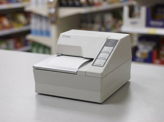 Epson TM-U295 compact slip printer in Epson Cool White on a retail checkout counter — AI-generated image