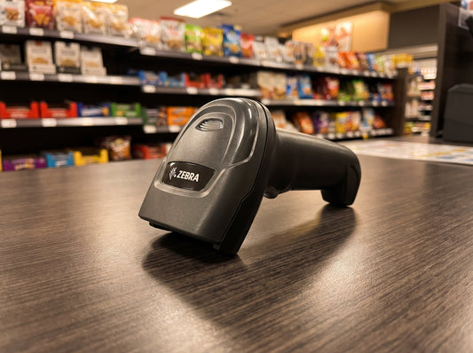 Zebra DS2208 corded 1D/2D barcode scanner in Twilight Black, scanner only, resting on a retail checkout counter