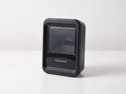 Honeywell Genesis XP 7680g hands-free presentation area imager in black on a cafe counter — AI-generated image