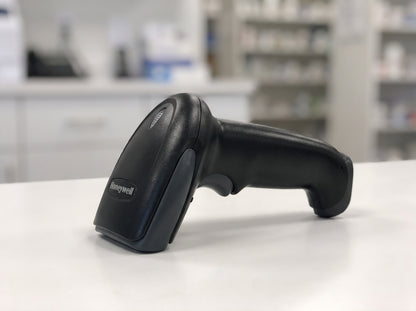 Honeywell Hyperion 1300g corded 1D linear imaging barcode scanner in black on a retail checkout counter — AI-generated image