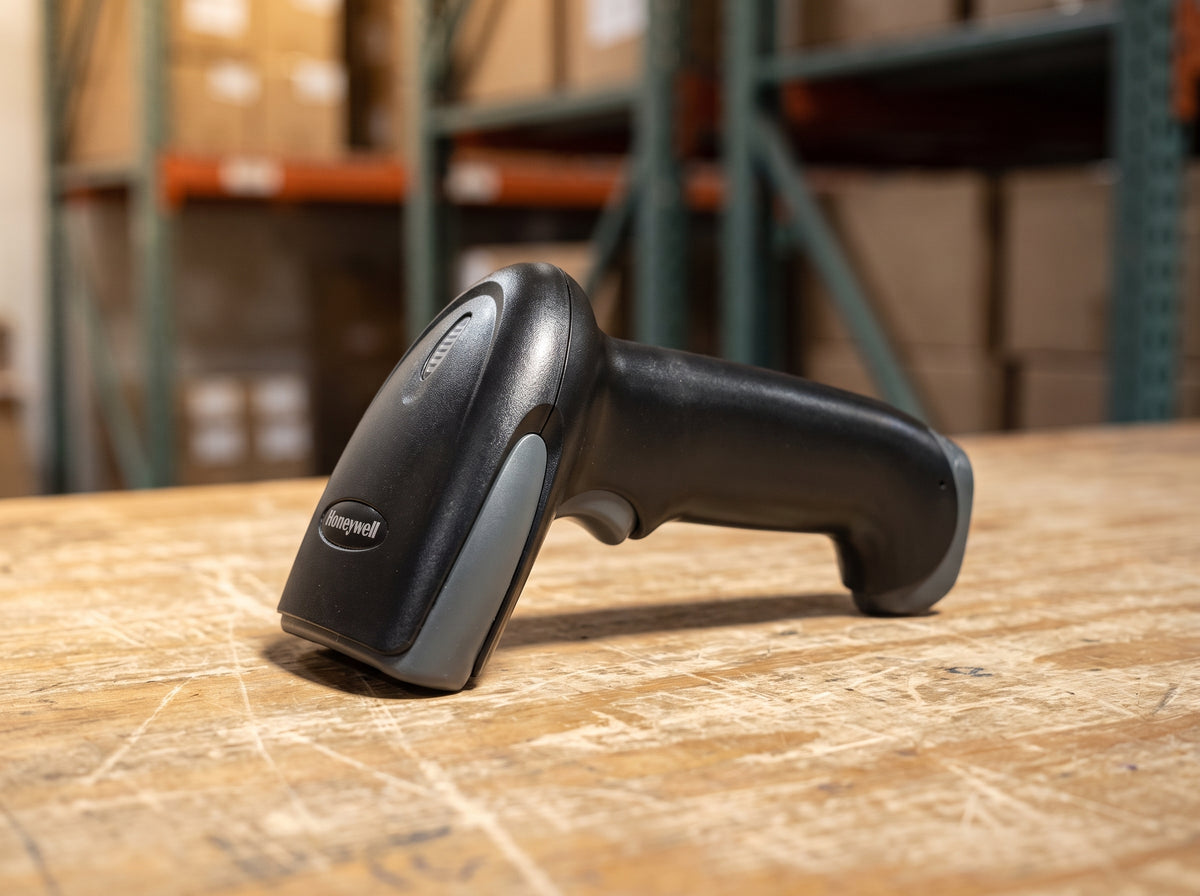 Honeywell Hyperion 1300g corded 1D linear imaging barcode scanner in black on a cafe counter — AI-generated image
