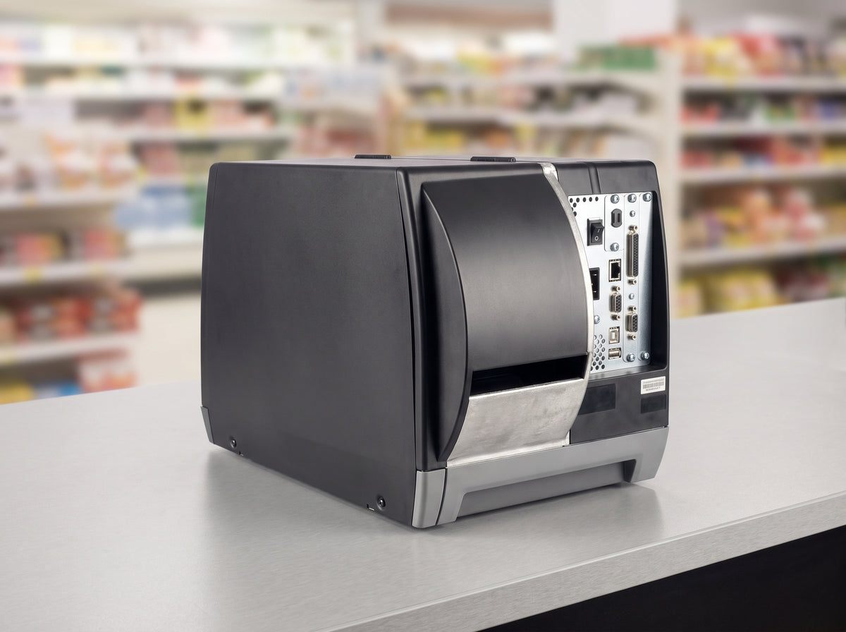 Honeywell PM45A industrial label printer in dark grey, connector side on a retail checkout counter — AI-generated image