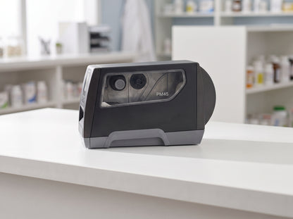 Honeywell PM45A industrial label printer in dark grey on a retail checkout counter — AI-generated image