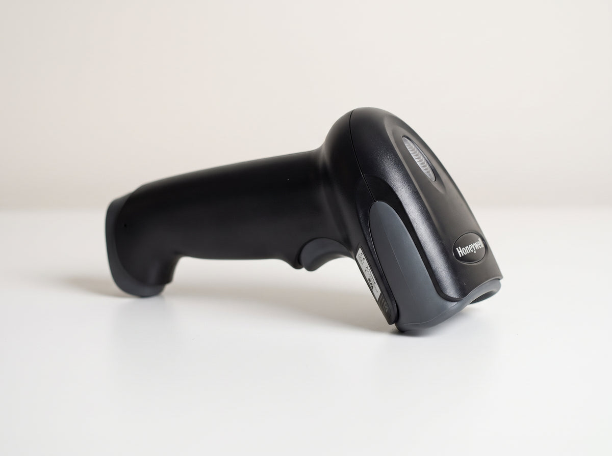Honeywell Voyager 1250g corded 1D laser barcode scanner in black on a retail checkout counter — AI-generated image