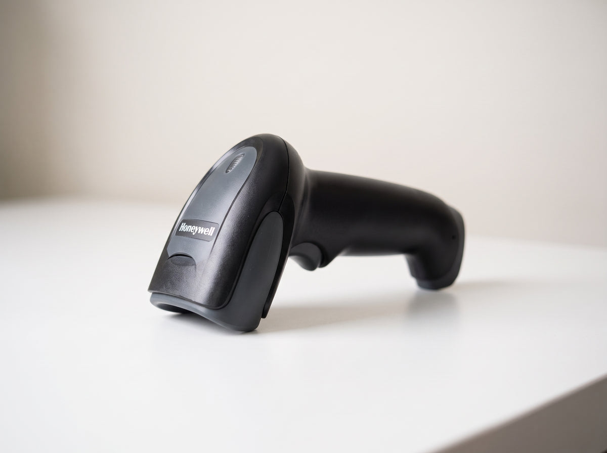 Honeywell Voyager 1250g corded 1D laser barcode scanner in black on a retail checkout counter — AI-generated image