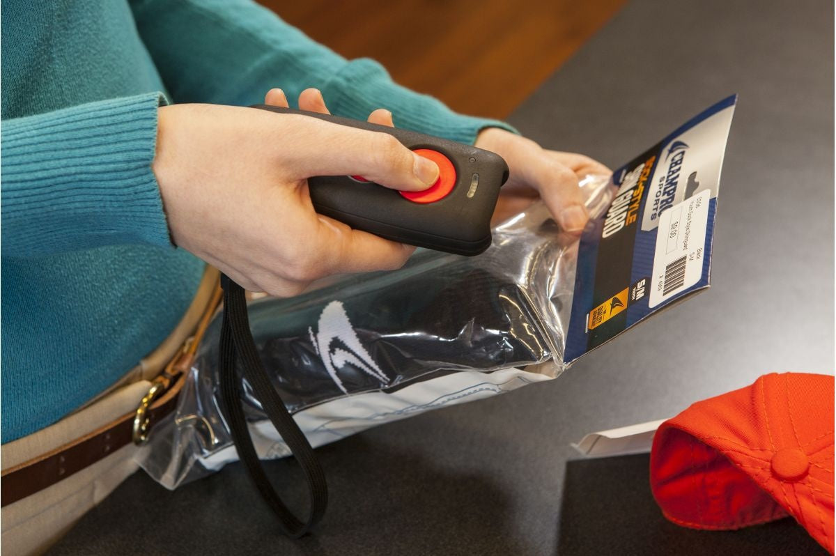 Honeywell Voyager 1602g — pocket scanner scanning a packaged item