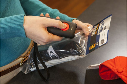Honeywell Voyager 1602g — pocket scanner scanning a packaged item