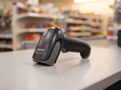 Honeywell Voyager XP 1470g corded 2D area imager barcode scanner in black on a retail checkout counter — AI-generated image