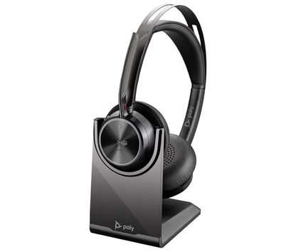 Poly Voyager Focus 2 — headset seated on its charge stand