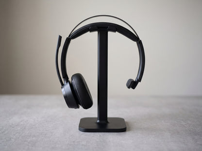 Poly Voyager Focus 2 headset resting on its charge stand — AI-generated image