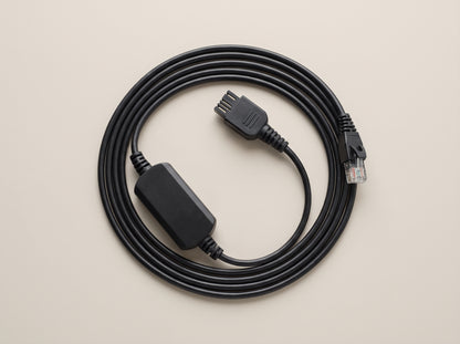 Poly APP-51 electronic hookswitch cable coiled flat, both connector ends visible  — AI-generated image