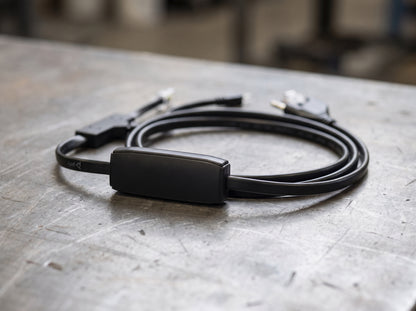 Poly APP-51 electronic hookswitch cable with its inline module on a workbench  — AI-generated image