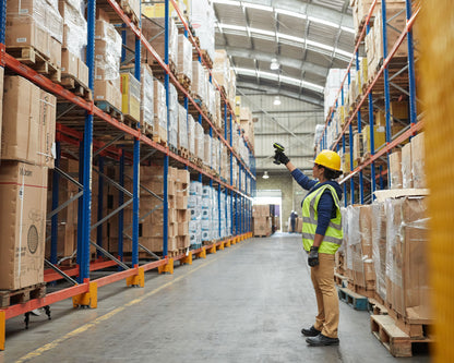 Zebra ultra-rugged cordless scanner reading a rack label in a warehouse aisle