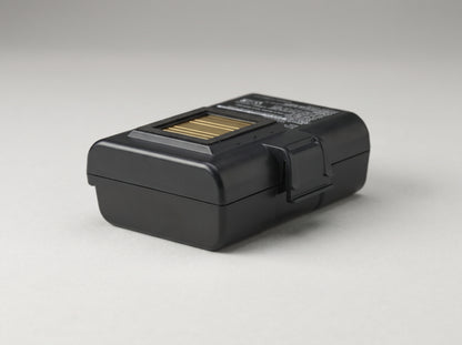 Zebra extended smart battery for ZQ500 and ZQ600 mobile printers, contact end toward the camera — AI-generated image