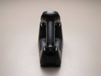 Zebra LI4278 cordless linear imager seated in its charging cradle, rear view — AI-generated image