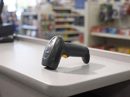 Zebra LI4278 cordless Bluetooth 1D linear imager scanner in black on a retail checkout counter, scanner only — no cradle, cable or power supply included — AI-generated image