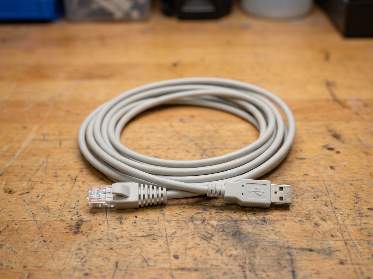 Zebra CBA-U01 light grey straight USB Series A scanner cable coiled on a workbench — AI-generated image