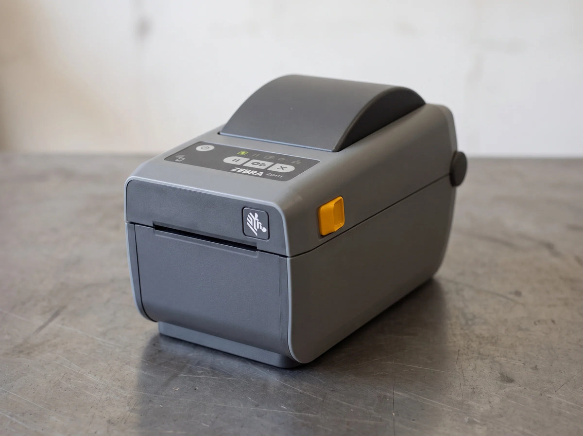 Zebra ZD411 2-inch direct thermal desktop label printer, front three-quarter view of the control panel — AI-generated image