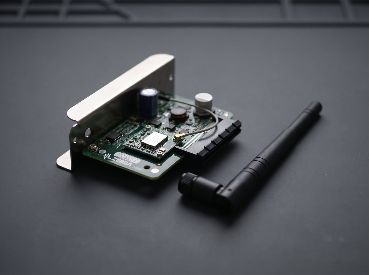 Zebra ZebraNet 802.11ac wireless card and stub antenna on an antistatic mat — AI-generated image