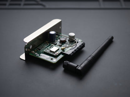 Zebra ZebraNet 802.11ac wireless card and stub antenna on an antistatic mat — AI-generated image